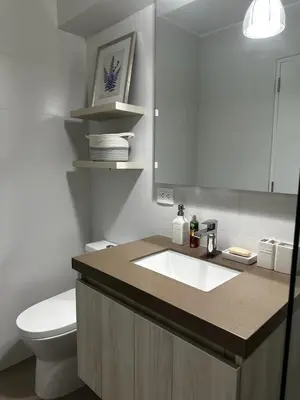 a bathroom with a sink and a toilet and a mirror at Departamento Calido y familiar in Lima
