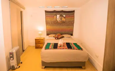 a small bedroom with a bed in a room at RumiUma Boutique Hotel in Cusco