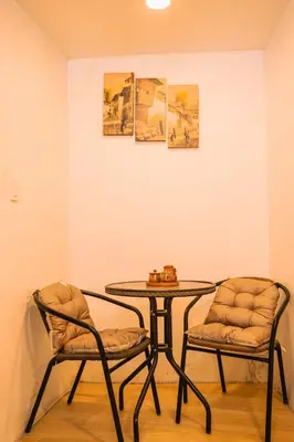 a table and two chairs in a room with a table at RumiUma Boutique Hotel in Cusco