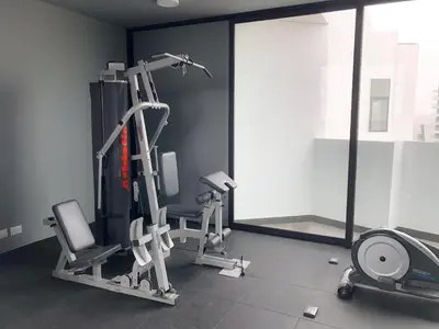 a gym with two tread machines and a treadmill at Departamento exclusivo a un paso de San Isidro in Lima