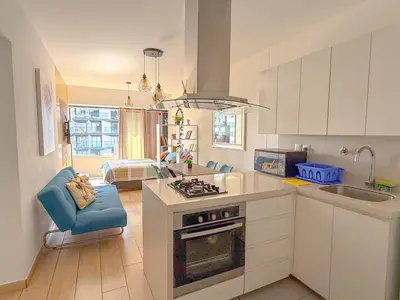 a kitchen with a sink and a stove top oven at Departamento exclusivo a un paso de San Isidro in Lima