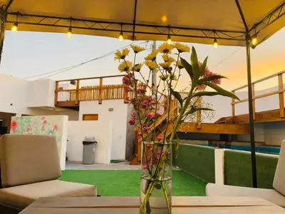 a vase filled with flowers sitting on a table at El Templo Surf House in Punta Hermosa