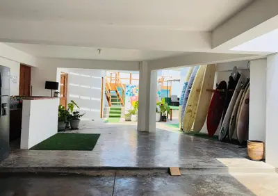 a room with a bunch of surfboards on the wall at El Templo Surf House in Punta Hermosa