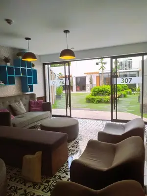 a living room with couches and chairs and a large window at Refugio en Barranco, Private Apartament in Barranco in Lima