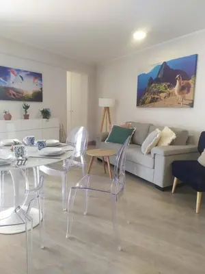 a living room with a couch and a table and chairs at Refugio en Barranco, Private Apartament in Barranco in Lima