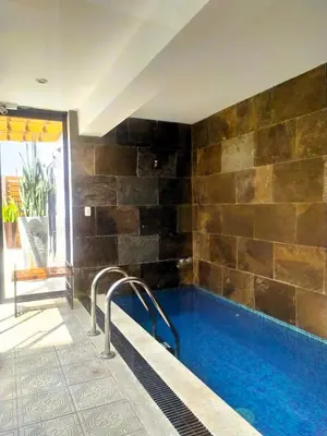 a swimming pool in a house with a tile wall at Refugio en Barranco, Private Apartament in Barranco in Lima