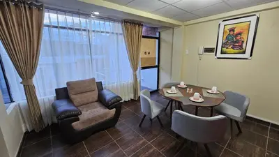 a living room with a table and a couch and a chair at Casa Independiente cerca al Centro en Segundo Piso - Los Profesionales in Cusco
