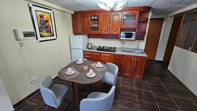 a kitchen with a table and chairs in a room at Casa Independiente cerca al Centro en Segundo Piso - Los Profesionales in Cusco