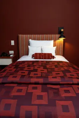 a bedroom with a large bed with two pillows at Mamasara Machupicchu in Machu Picchu