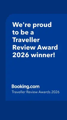 a blue sign that says were proud to be a traveller reviewagency winner at Mamasara Machupicchu in Machu Picchu