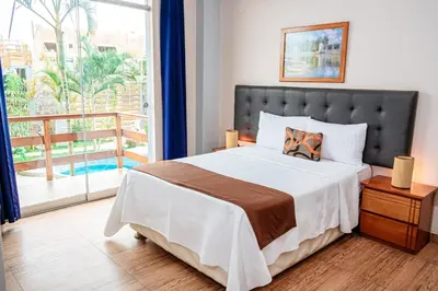a bedroom with a large bed and a balcony at GRAN HOTEL VILLA DEL SUR in San Vicente de Cañete