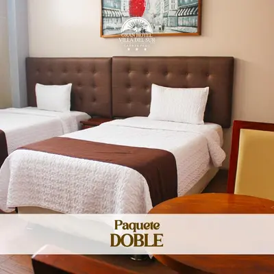 two beds in a hotel room with a large headboard at GRAN HOTEL VILLA DEL SUR in San Vicente de Cañete