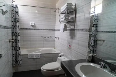 a bathroom with a tub and a toilet and a sink at Hotel Tierra Inka Sacred Valley in Ollantaytambo