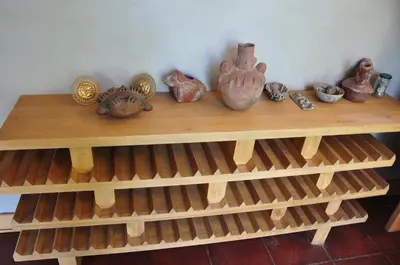 a wooden shelf with vases and other items on it at Valle Dorado Lodge in Cusco