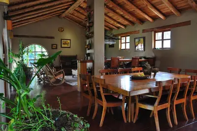 a dining room with a wooden table and chairs at Valle Dorado Lodge in Cusco