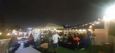 a group of people sitting in a crowd at night at Quinoa Backpackers Hostel in Lima