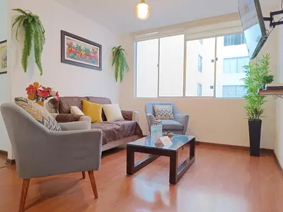 a living room with a couch and a coffee table at Runawasi Apartments - José Gonzales 3BDR, near to Larcomar in Lima