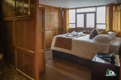 a bedroom with a bed and a window on a boat at WARM AND CENTRAL HOUSE WITH SPECTACULAR VIEW OF CUSCO in Cusco