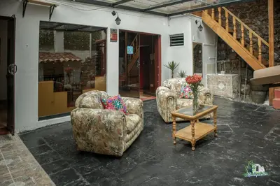 two chairs and a table with a vase of flowers at WARM AND CENTRAL HOUSE WITH SPECTACULAR VIEW OF CUSCO in Cusco