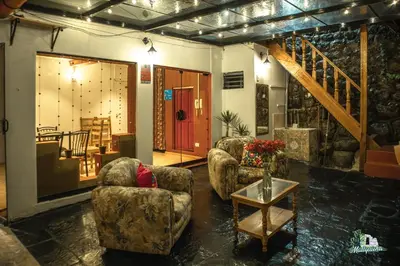 a living room with two chairs and a table at WARM AND CENTRAL HOUSE WITH SPECTACULAR VIEW OF CUSCO in Cusco