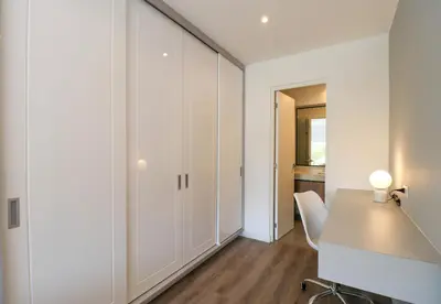 a white office with a desk and a chair at Alameda by Wynwood House in Lima