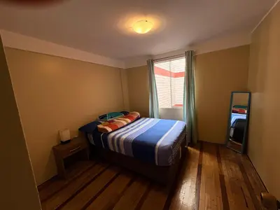 a small bedroom with a bed and a window at Departamento cerca al boulevard in Lima
