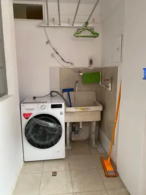 a laundry room with a washing machine and a sink at Departamento cerca al boulevard in Lima