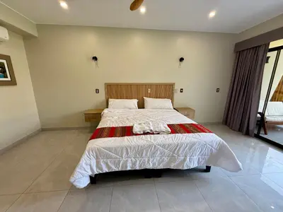 a bedroom with a large bed in a room at Los Andes - Restaurant & Bungalows in Cieneguilla
