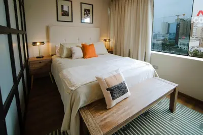 a hotel room with a large bed and a window at Designed Studio in Miraflores / Amazing View in Lima