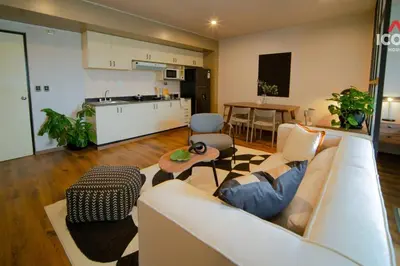 a living room with a couch and a kitchen at Designed Studio in Miraflores / Amazing View in Lima