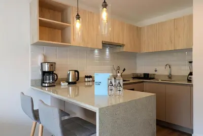 a kitchen with a counter with two bottles on it at Los Pinos by Wynwood House in Lima