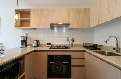 a kitchen with a stove top oven next to a sink at Los Pinos by Wynwood House in Lima