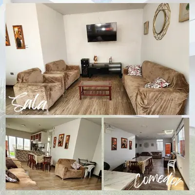 a living room with a couch and a table at Casa de Campo El Huerto in Lima