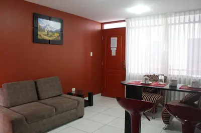 a living room with a couch and a table at El Peregrino Apart Hotel in Abancay