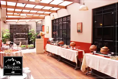 a restaurant with two tables in a room at El Peregrino Apart Hotel in Abancay