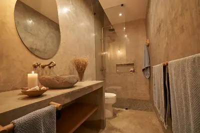 a bathroom with a sink and a toilet and a mirror at Relájate en piscina-spa, terraza BBQ y AC Paracas in Paracas