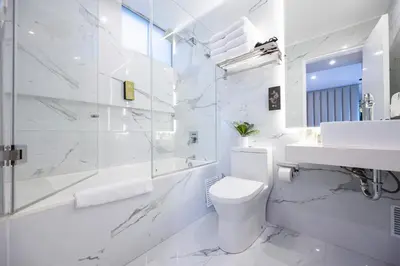 a white bathroom with a toilet and a sink at Penthouse Luxe private Jacuzzi King AC in Lima