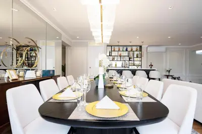 a dining room with a black table and white chairs at Penthouse Luxe private Jacuzzi King AC in Lima