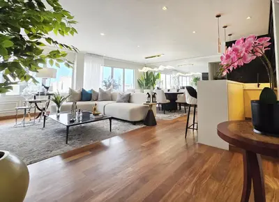 a living room with a couch and a table at Penthouse Luxe private Jacuzzi King AC in Lima