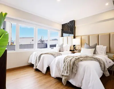 two beds in a room with two windows at Penthouse Luxe private Jacuzzi King AC in Lima
