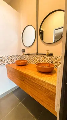 two sinks in a bathroom with two mirrors at Black Llama Hostel Cusco in Cusco