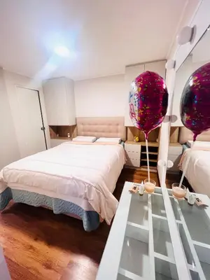 a bedroom with a large bed and a glass table at Pacific Apartamento Surco in Lima