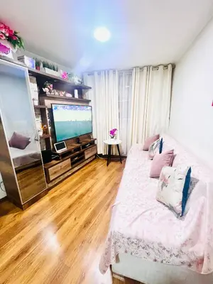 a living room with a bed and a flat screen tv at Pacific Apartamento Surco in Lima