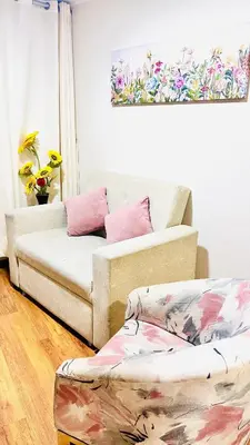 a living room with two couches and pink pillows at Pacific Apartamento Surco in Lima
