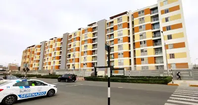 a police car parked in front of a large building at Pacific Apartamento Surco in Lima