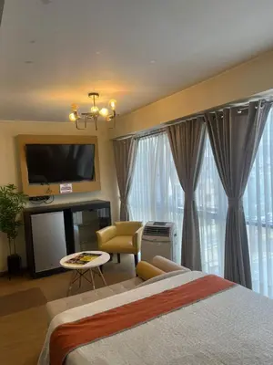 a hotel room with a bed and a tv and curtains at LOS ARCES HOTEL in Lima