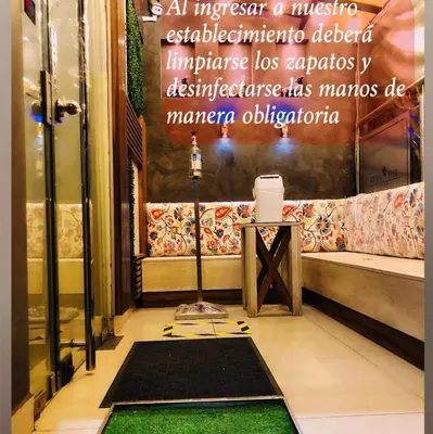 a room with a bench and a table with a camera at LOS ARCES HOTEL in Lima