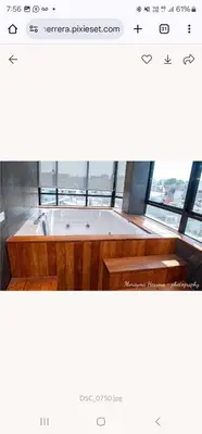 a bath tub in a room with a window at LOS ARCES HOTEL in Lima