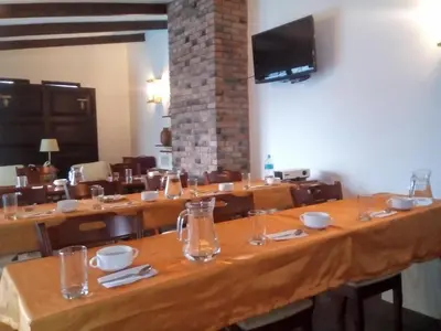 a large dining room with wooden tables and chairs at Apart Hotel El Doral in Lima