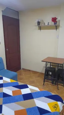 a room with a bed and a table with chairs at 202 Comfy Apt WiFi kitchen SmartTV Central at Callao in Lima